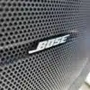 Close-up of a Bose speaker grille featuring a honeycomb pattern and the Bose logo at its center, akin to the precision in a 2016 GMC Acadia Denali AWDs detailed design.