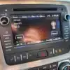 The radio screen in the 2016 GMC Acadia Denali AWD displays boom 97.3 FM, a clear signal, and the temperature at 5°C at 11:04 AM. Its surrounded by buttons and controls and hints at AWD performance with extra AM channels listed below.