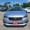 A 2018 Subaru Impreza Sport w/ Tech pkg, in silver, is parked at Boss Auto with a green Certified sticker on the windshield. Other cars gleam in the background under a clear blue sky.