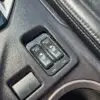 Close-up of seat heating controls on a 2018 Subaru Impreza Sports console. Two switches labeled HI and LO accompany heated seat icons. The console, enhanced with leather accents, includes a cup holder as part of the Tech pkg upgrade.